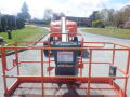 A 2008 JLG Boom Lift with a raised platform and control panel visible at the front