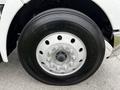 Close-up of the wheel of a 2014 Kenworth T370 featuring a multi-bolt pattern and a black tire with visible tread markings
