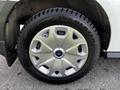 Close-up of a silver wheel rim with a Ford logo and a black tire labeled Ice Blazer on a 2016 Ford Transit Connect