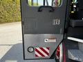 A 2006 Emergency One Fire Truck with an open door showing a red and white striped panel and a circular light at the bottom of the door