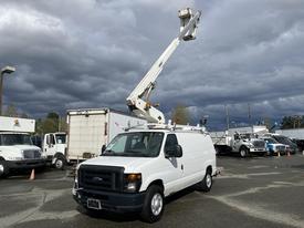 A white 2008 Ford Econoline van with an extended bucket lift apparatus raised above the vehicle