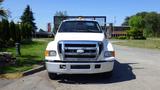 A white 2006 Ford F-650 truck with a large front grille and headlights facing forward