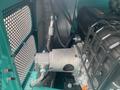 A close-up view of the engine compartment of a 2024 AGT Industrial MH12R Mini Excavator showing machinery components and wiring