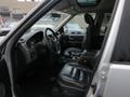 Interior view of a 2006 Land Rover LR3 showing the driver's seat steering wheel and dashboard with black leather upholstery and various controls