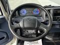 Interior view of a 2006 Hino 268 showcasing the steering wheel dashboard gauges and control panels