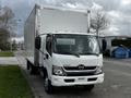A 2019 Hino 195 box truck in white with a large cargo area and a front cab featuring a black grille and headlights