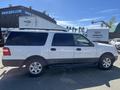 A white 2013 Ford Expedition parked with a black lower body trim and chrome accents visible on the side