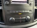 The dashboard control panel of a 2020 Mercedes-Benz Metris featuring climate controls radio buttons and display screen