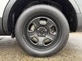 A close-up view of a black alloy wheel with a tire on a 2019 Ford Explorer showcasing five spokes and tread pattern