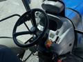 Interior view of a 2018 New Holland Boomer 45 tractor's cockpit featuring a steering wheel dashboard and control levers