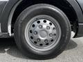 Close-up of a silver wheel with five lug nuts on a black tire on a 2022 Ford Transit