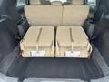 The image shows the rear interior of a 2016 Ford Explorer with two folded beige fabric seats in the upright position