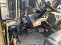 Close-up of the control panel and seat of a 1993 Hyster H80XL forklift showing levers switches and foot pedals
