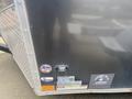A 2020 Stealth Enterprises trailer featuring a metallic surface with various stickers and a light fixture on the exterior near the bottom edge