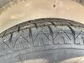 Close-up view of a tire tread featuring deep grooves and a sturdy design indicating a 2020 Mirage Enterprises 12 Foot Cargo vehicle