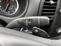 Close-up of the gear shift lever of a 2023 Mercedes-Benz Metris with indicators for reverse neutral and drive, featuring a sleek design and controls for manual shifting