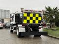 A 2016 Freightliner 108SD truck with a brightly colored yellow and black checkerboard safety sign mounted on the back
