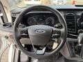 Steering wheel of a 2023 Ford Transit featuring the Ford logo and various control buttons on the spokes