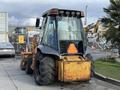 A 2005 Case 570 construction tractor featuring a rear loader large tires and a triangular safety sign on the back