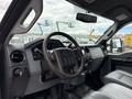 Interior view of a 2015 Ford F-350 SD showing the steering wheel dashboard and control panel with leather seats visible