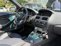 Interior view of a 2004 BMW 6-Series highlighting the steering wheel dashboard gear shift and control panel with leather seats