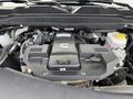 Engine compartment of a 2024 RAM 2500 featuring a 6.7L turbo diesel engine with various components and fluid reservoirs visible