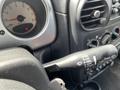 A 2005 Chrysler PT Cruiser interior close-up showing the steering column with a turn signal lever and dashboard gauges
