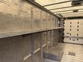 Interior of a 2018 Ford Econoline with metal walls and a raised platform at the back for cargo storage