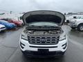A 2016 Ford Explorer with its hood raised displaying the engine compartment and various components inside