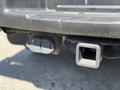 A 2014 Ford F-150 towing hitch and wiring connector are visible in the foreground
