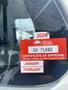 A 2015 International TerraStar windshield displaying a red certificate of approval and tags for January and February 2026