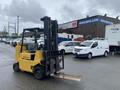 A yellow 2010 Hyster S80XLBCS forklift with a raised fork in the foreground
