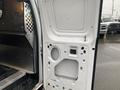 The image shows the inside of a 2011 Ford Econoline van with the rear door open revealing a metal framework and paneling