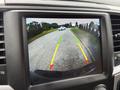 A rearview camera display showing the path of a 2018 RAM 1500 with guidelines in red yellow and green for parking assistance