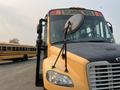 A yellow 2007 Freightliner B2 school bus with a front mounted mirror and clear windshield displaying the words SCHOOL BUS on the top