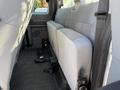 Interior view of the back seat of a 2012 Ford F-350 SD with gray fabric seats and a rubber floor mat