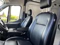 Interior of a 2021 Ford Transit showing two black leather front seats with armrests and a simple dashboard design