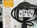 A control panel with various buttons and switches for operating a vehicle or equipment, featuring labels for engine start, platform lift, and boom controls