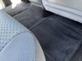 Close-up of the fabric seat of a 2014 Ford F-150 with a view of a dark carpeted floor mat