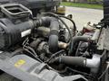 Close-up view of the engine compartment of a 2006 Hino 268 showing various components including hoses and a turbocharger
