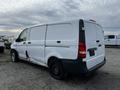 A white 2018 Mercedes-Benz Metris van with a missing door handle and a black rear bumper parked among other vehicles