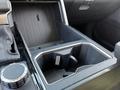 Interior console compartment of a 2023 Toyota Tundra showing an empty cup holder and textured surface
