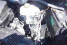 A 2012 Mercedes-Benz Sprinter engine compartment showing various components including the engine, battery, and fluid reservoirs