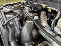 Close-up view of the engine compartment of a 2011 Ford F-550 featuring various pipes hoses and mechanical components