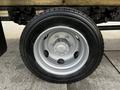 A close-up view of a silver wheel with five lug nuts and a black tire mounted on a 2019 Hino 195 vehicle
