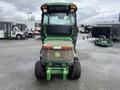 A 2014 John Deere 1585 Terrain Cut lawn mower with a green body and rear-mounted cabin visible from the back