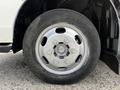 Close-up of a silver wheel with a six-bolt pattern and a black tire labeled Bridgestone on a 2004 Toyota Toyoace