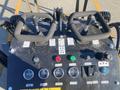 Controls of a 2024 AGT KTT23 featuring joysticks gauges and various buttons for operating the machinery