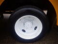 Close-up of a white wheel rim and black tire from a 2008 Freightliner MT45 Chassis