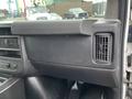 The interior dashboard of a 2012 Chevrolet Express featuring a glove compartment and an air vent